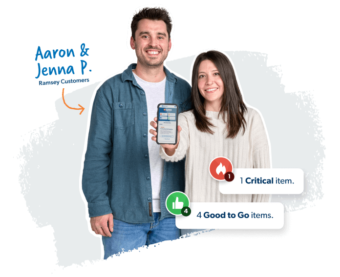 Couple standing while holding a phone with the Coverage Checkup on the screen